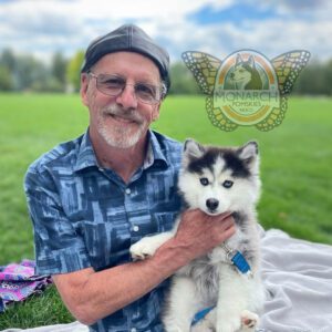 A man holding a dog in his arms.